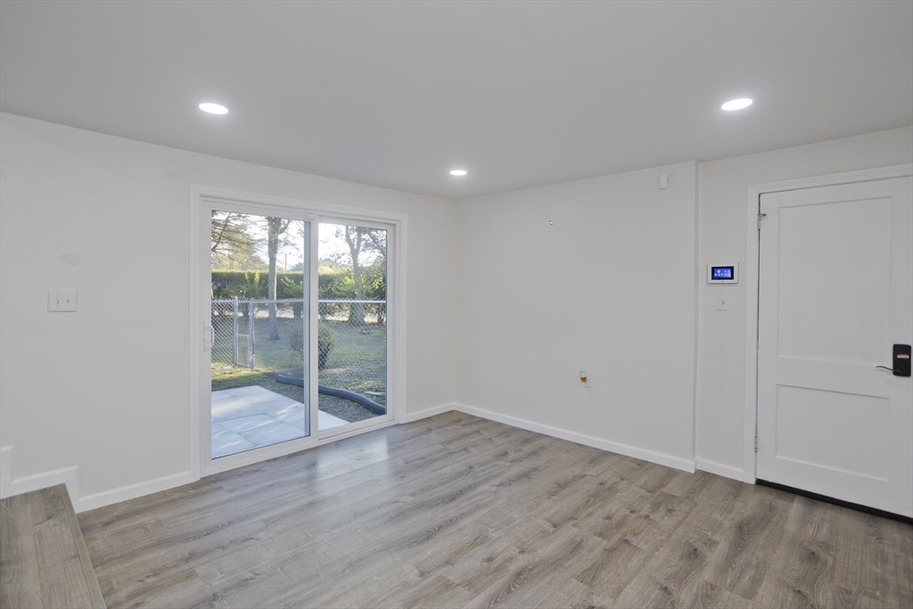 151 Fox Hill Road Springfield, MA 01118 - Photo 17 of 40 a view of an empty room with wooden floor and a window