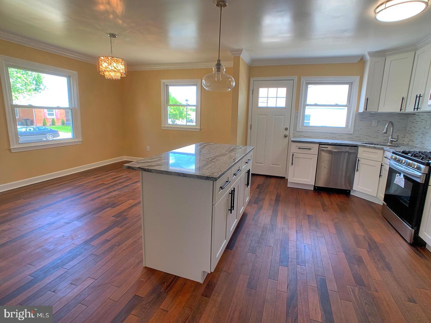7907 Subet Road Windsor Mill, MD 21244 - Photo 9 of 31 a kitchen with granite countertop wooden floors and wide window