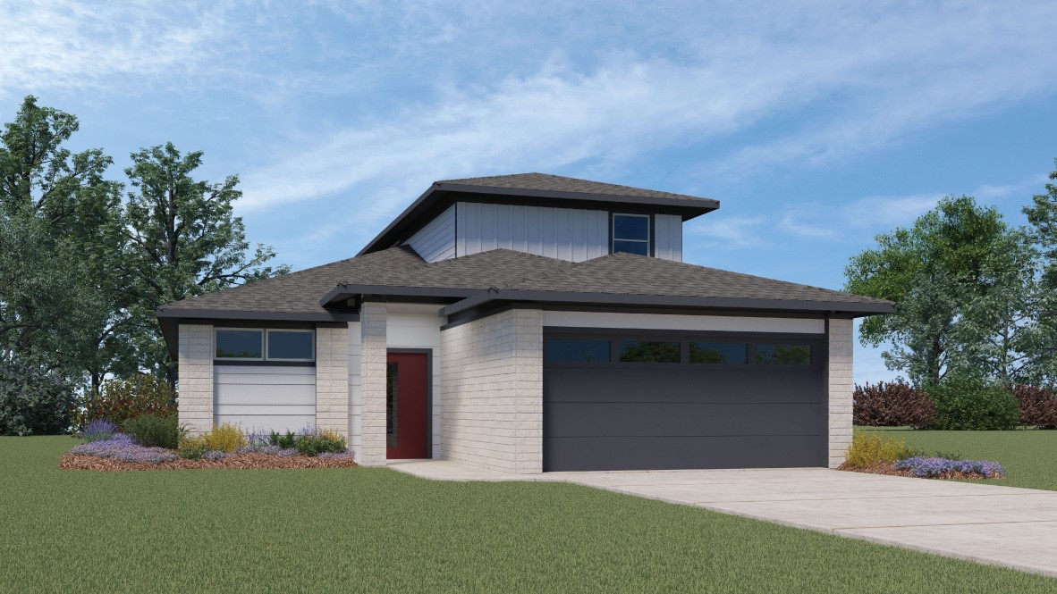 a front view of a house with a garden and yard