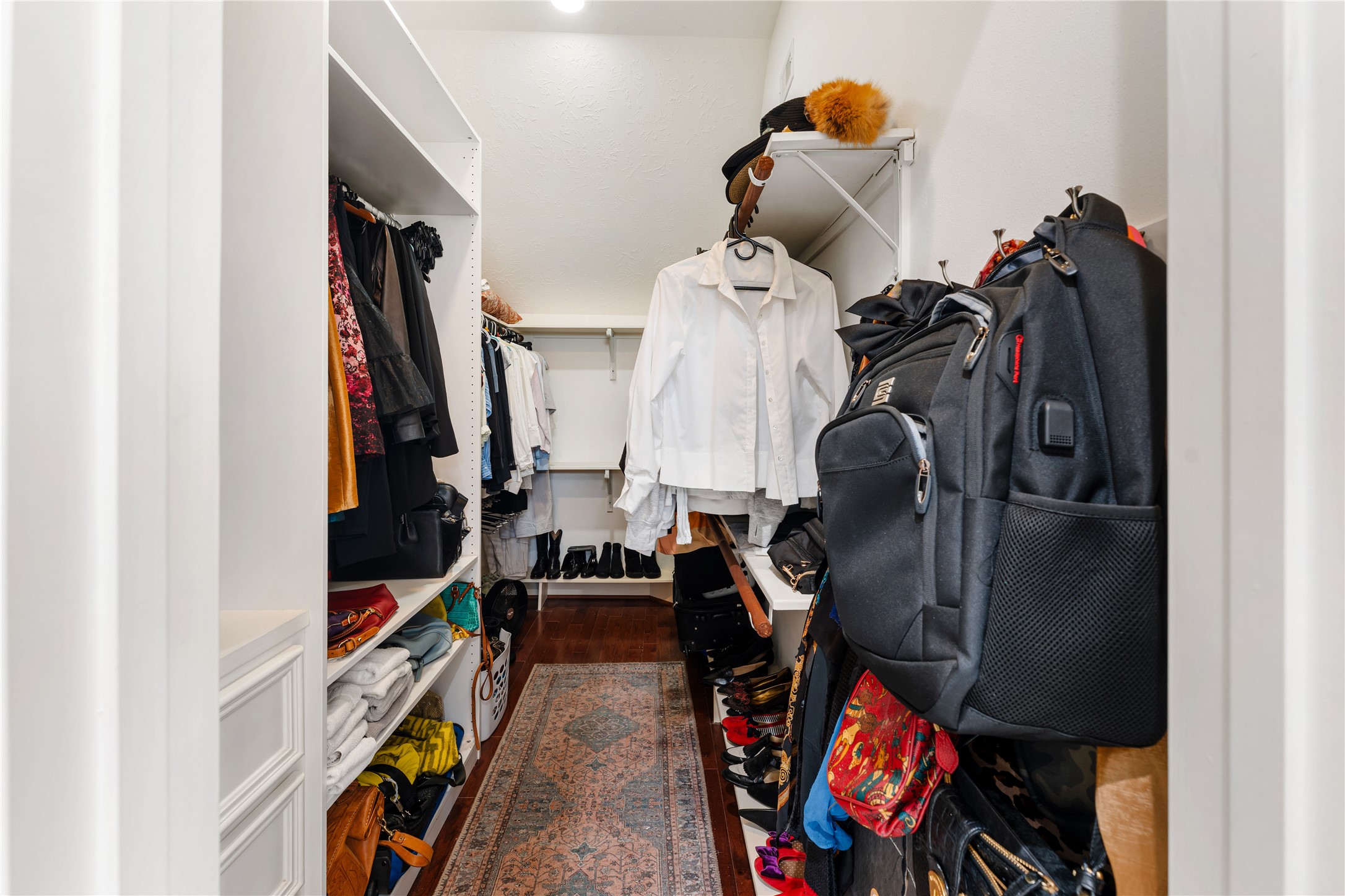 415 West 8th Street Houston, TX 77007 - Photo 15 of 39 An expansive walk-in closet offers exceptional storage with custom organization for wardrobes, shoes, and accessories. Designed to simplify daily living, the generous layout provides space to keep everything beautifully arranged. This impressive dressing area perfectly complements the home's spacious primary suite.