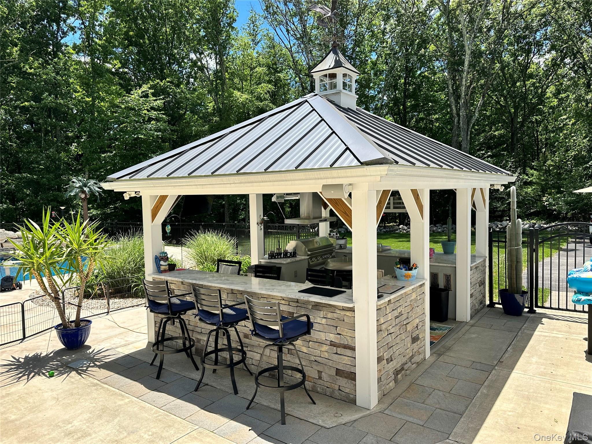 95 Weed Road Pine Bush, NY 12566 - Photo 20 of 31 Outdoor kitchen gazebo featuring a metal roof with a cupola, stone veneer base, granite countertop, and integrated grilling station