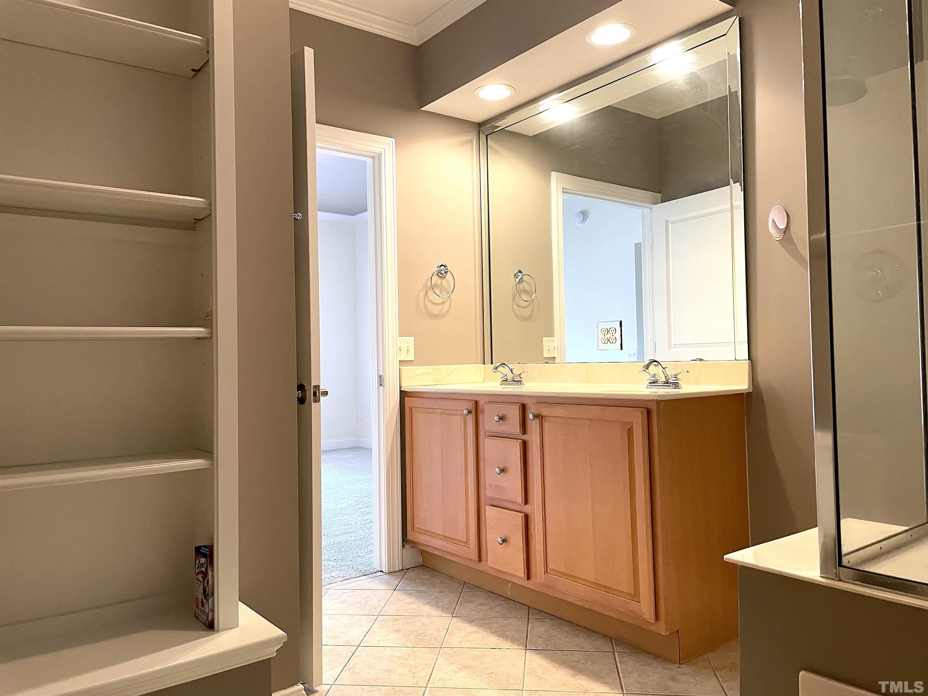 7510 Lead Mine Road, Unit 102 Raleigh, NC 27615 - Photo 14 of 25 a bathroom with a double vanity sink and a mirror