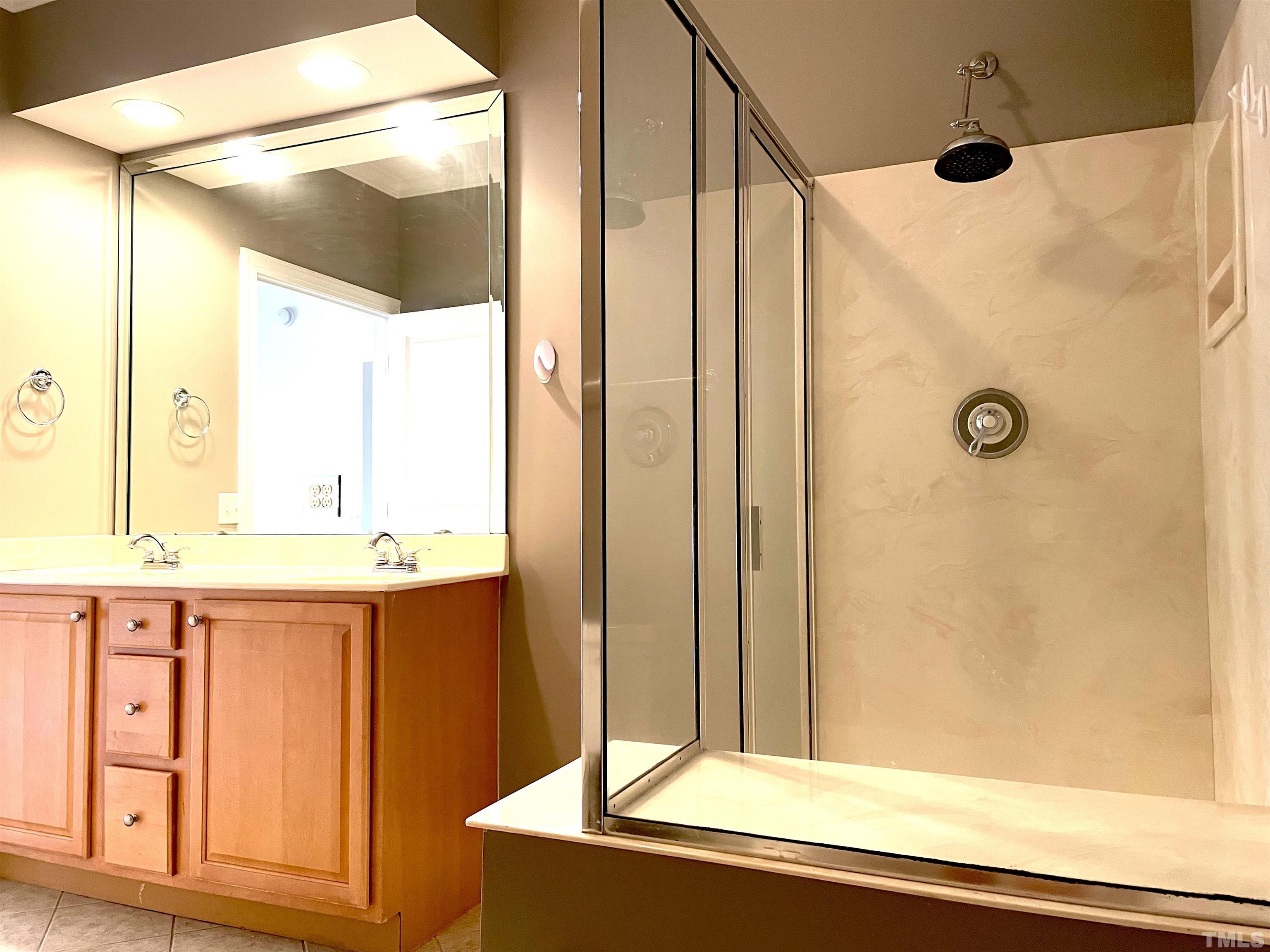 7510 Lead Mine Road, Unit 102 Raleigh, NC 27615 - Photo 15 of 25 a bathroom with a granite countertop sink and a mirror