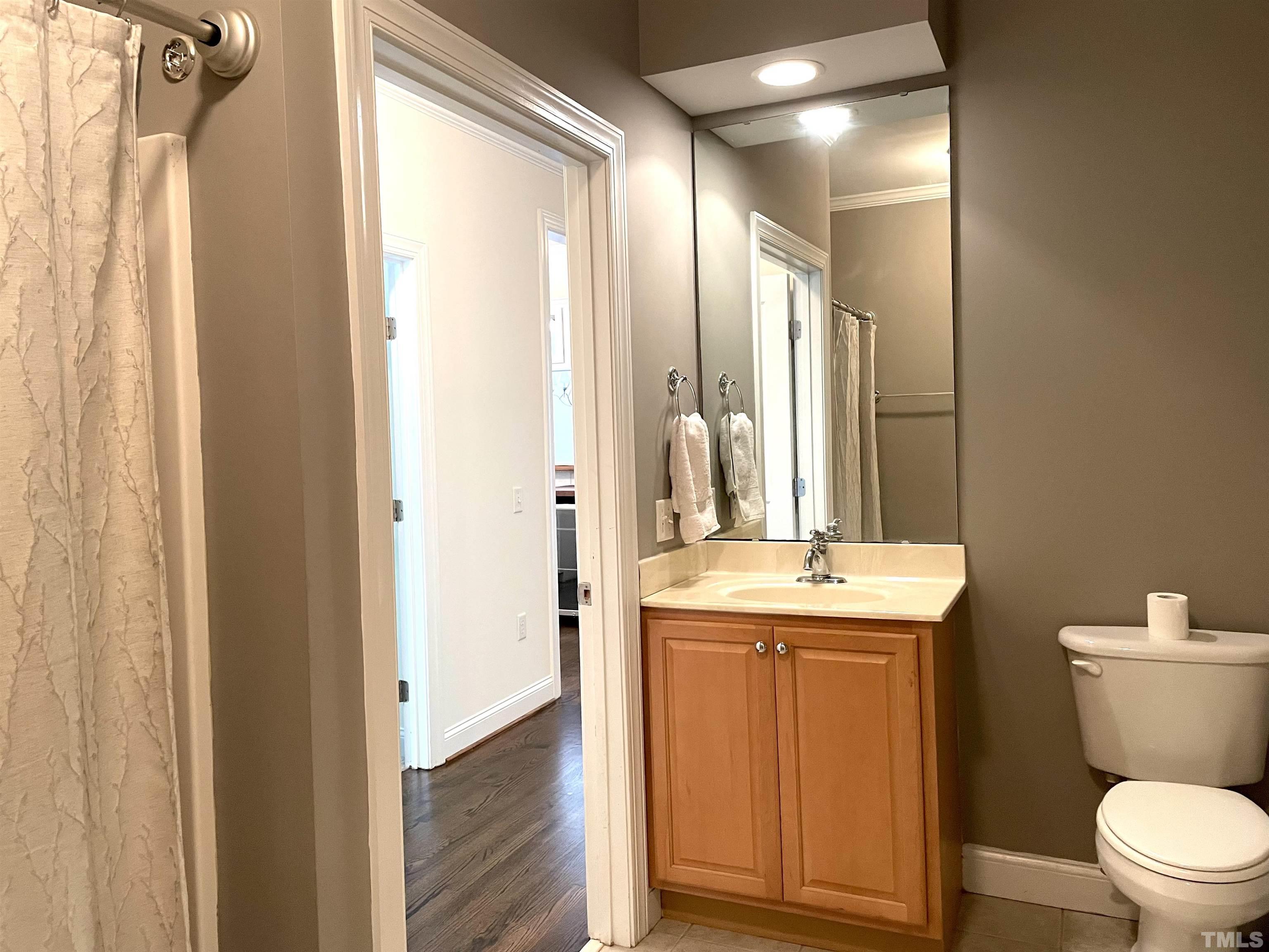 7510 Lead Mine Road, Unit 102 Raleigh, NC 27615 - Photo 21 of 25 a bathroom with a granite countertop sink toilet and shower