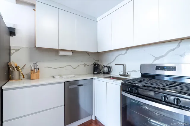 a kitchen with cabinets appliances and a sink