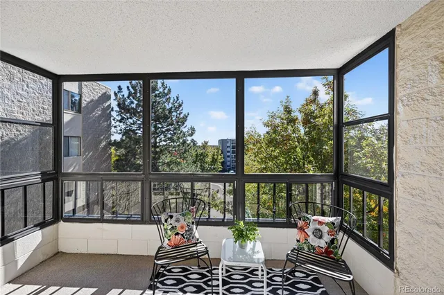 a view of a porch with furniture and garden