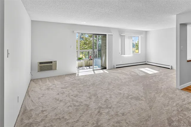 an empty room with windows and natural light