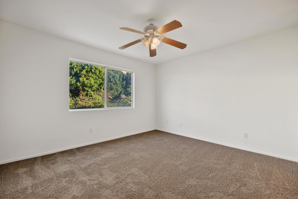 424 Dakota Way Oceanside, CA 92056 - Photo 13 of 31 an empty room with windows and ceiling fan