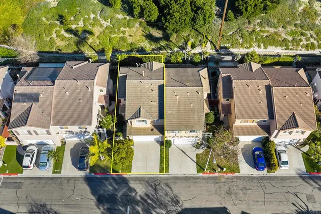 a view of a chair and table in backyard of the house