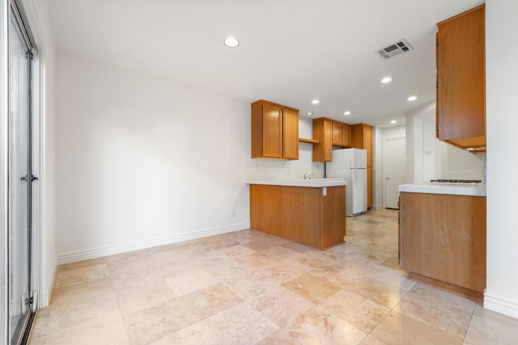 424 Dakota Way Oceanside, CA 92056 - Photo 5 of 31 a view of a kitchen with kitchen island granite countertop a sink and a refrigerator