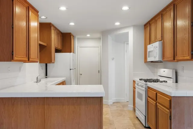 a kitchen with stainless steel appliances a sink a stove and a refrigerator