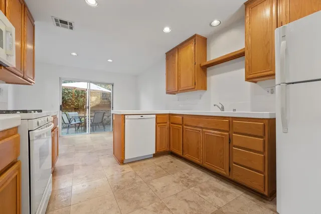 a kitchen with a sink stove and refrigerator