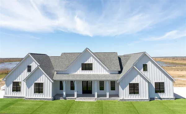 a front view of a house with a garden and yard
