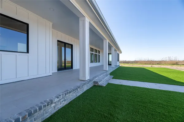 a front view of a house with a garden and yard