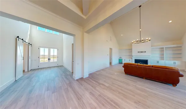 a large kitchen with sink and refrigerator