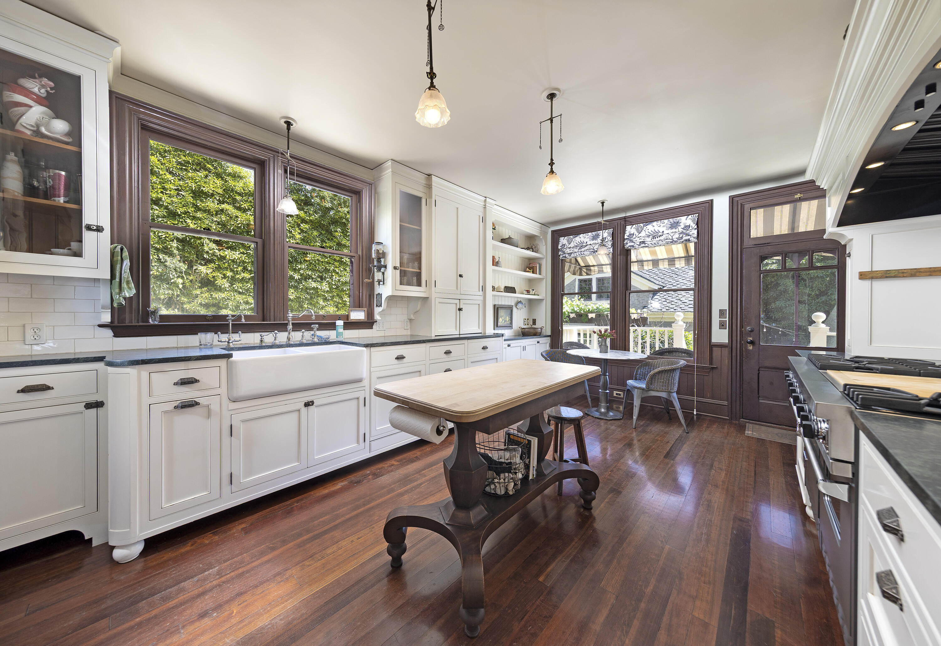 118 East Islay Street Santa Barbara, CA 93101 - Photo 13 of 44 a open kitchen with stainless steel appliances granite countertop a stove a refrigerator a sink a dining table and chairs with wooden floor