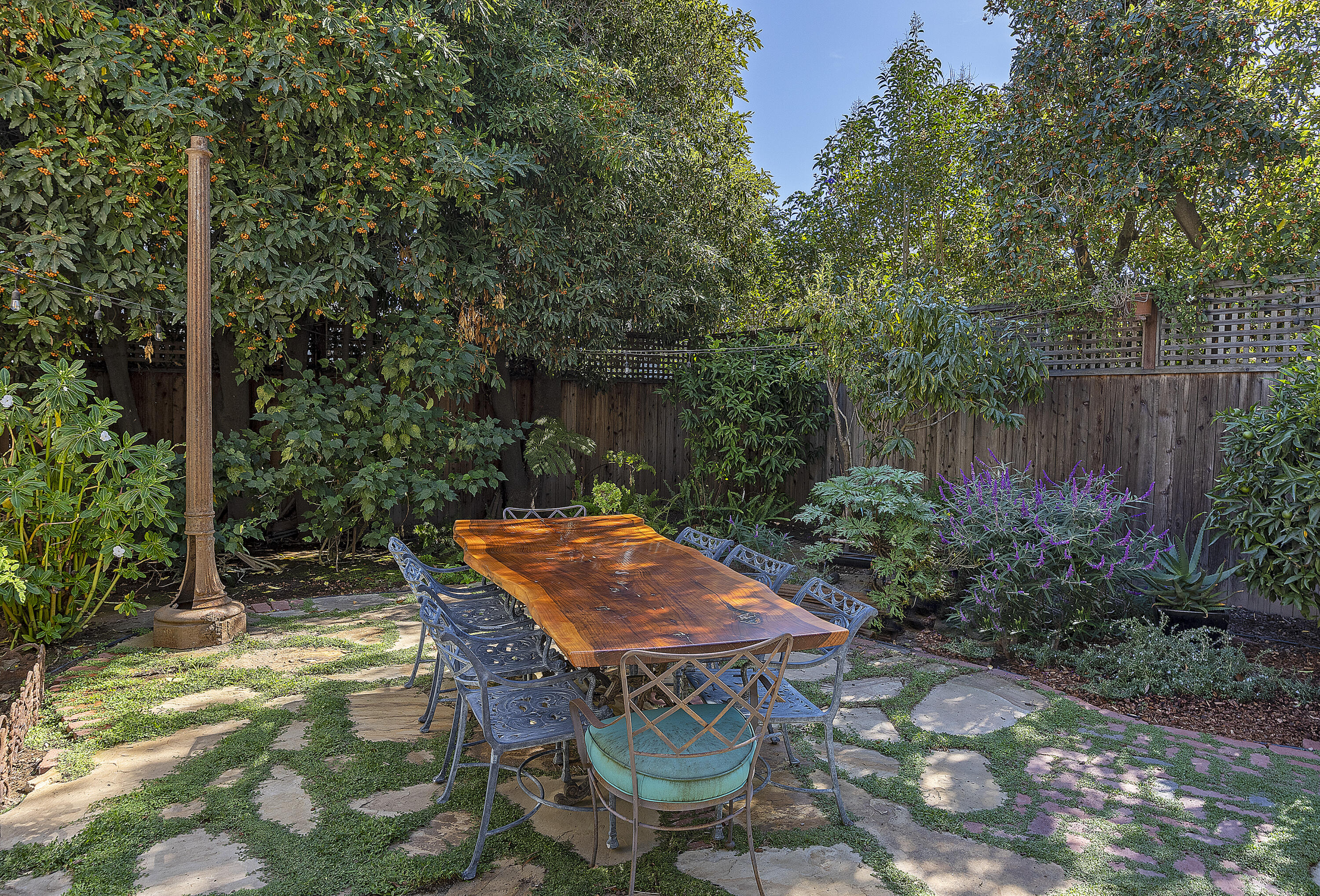 118 East Islay Street Santa Barbara, CA 93101 - Photo 40 of 44 a backyard of a house with table and chairs under an umbrella