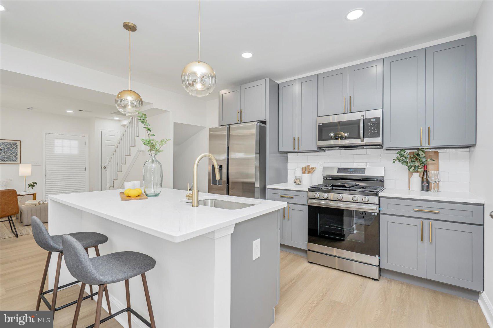 5412 Clover Road Baltimore, MD 21215 - Photo 11 of 42 a kitchen that has a sink stainless steel appliances and cabinets