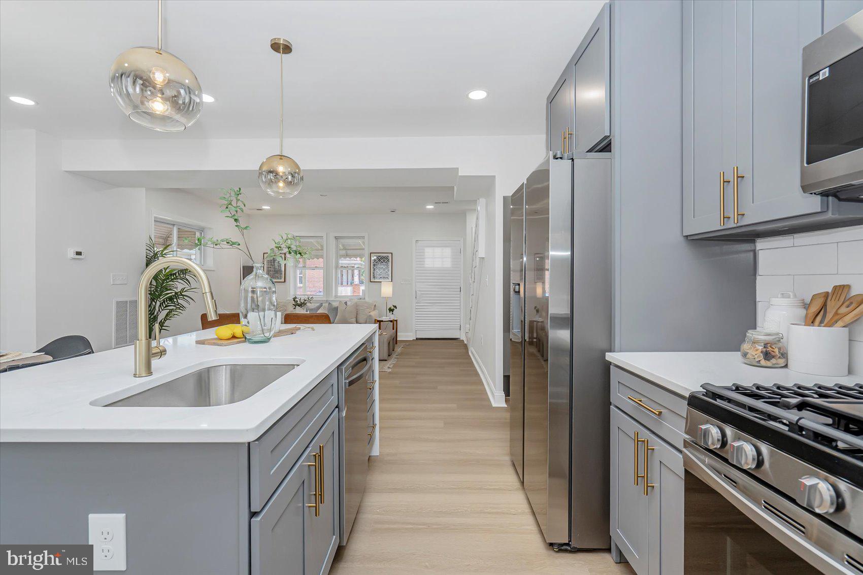 5412 Clover Road Baltimore, MD 21215 - Photo 12 of 42 a kitchen with sink a stove and refrigerator