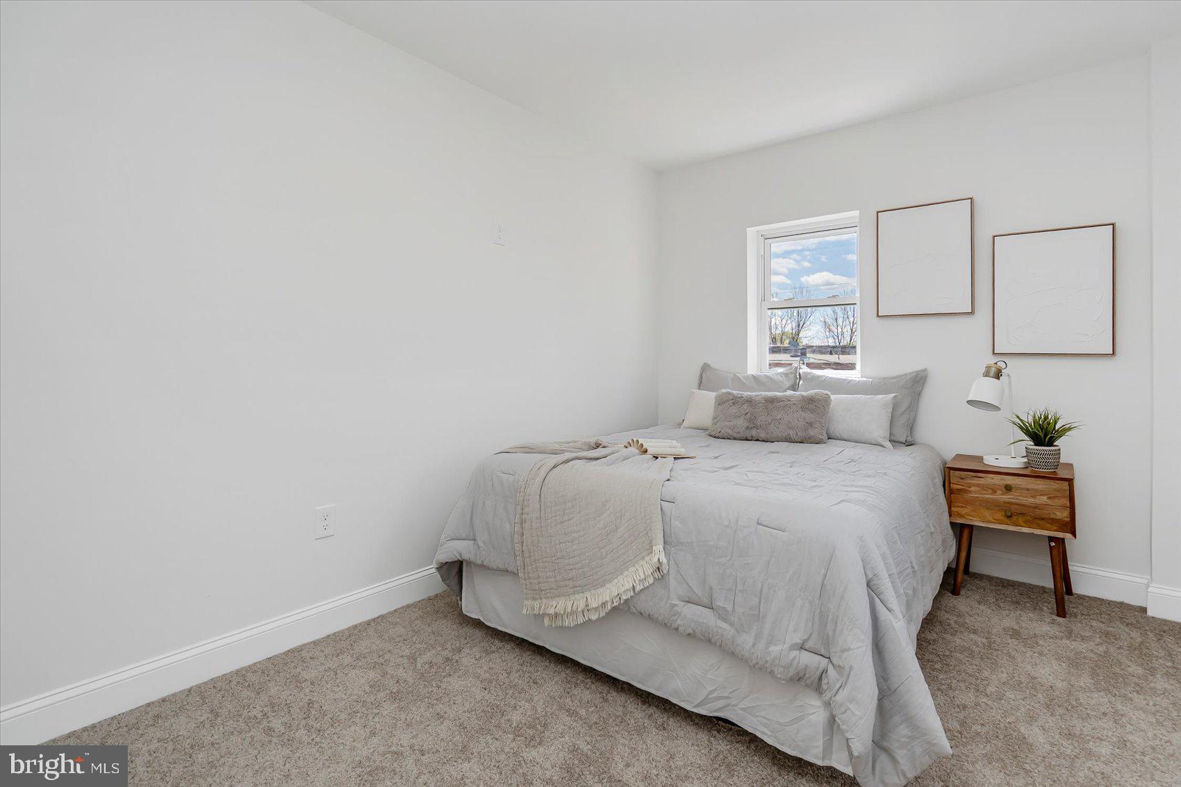 5412 Clover Road Baltimore, MD 21215 - Photo 30 of 42 a bedroom with a bed and a lamp on dresser
