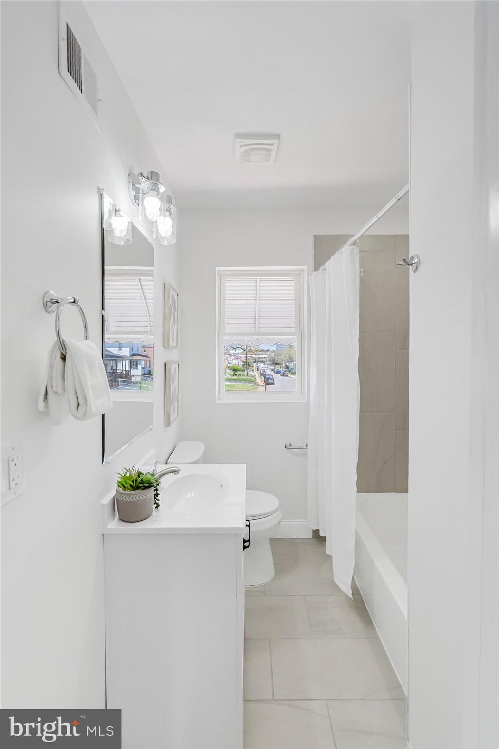 5412 Clover Road Baltimore, MD 21215 - Photo 32 of 42 a white bath tub sitting next to a white sink