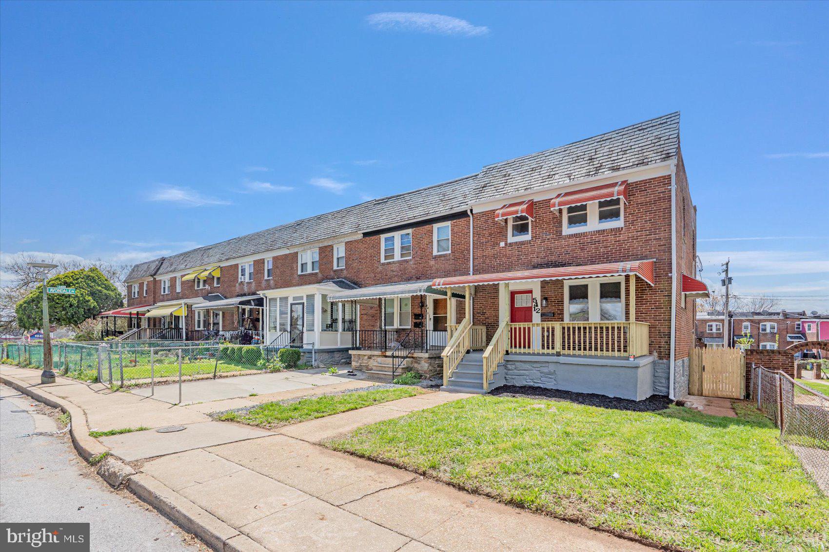 5412 Clover Road Baltimore, MD 21215 - Photo 40 of 42 a front view of a house with a yard table and chairs