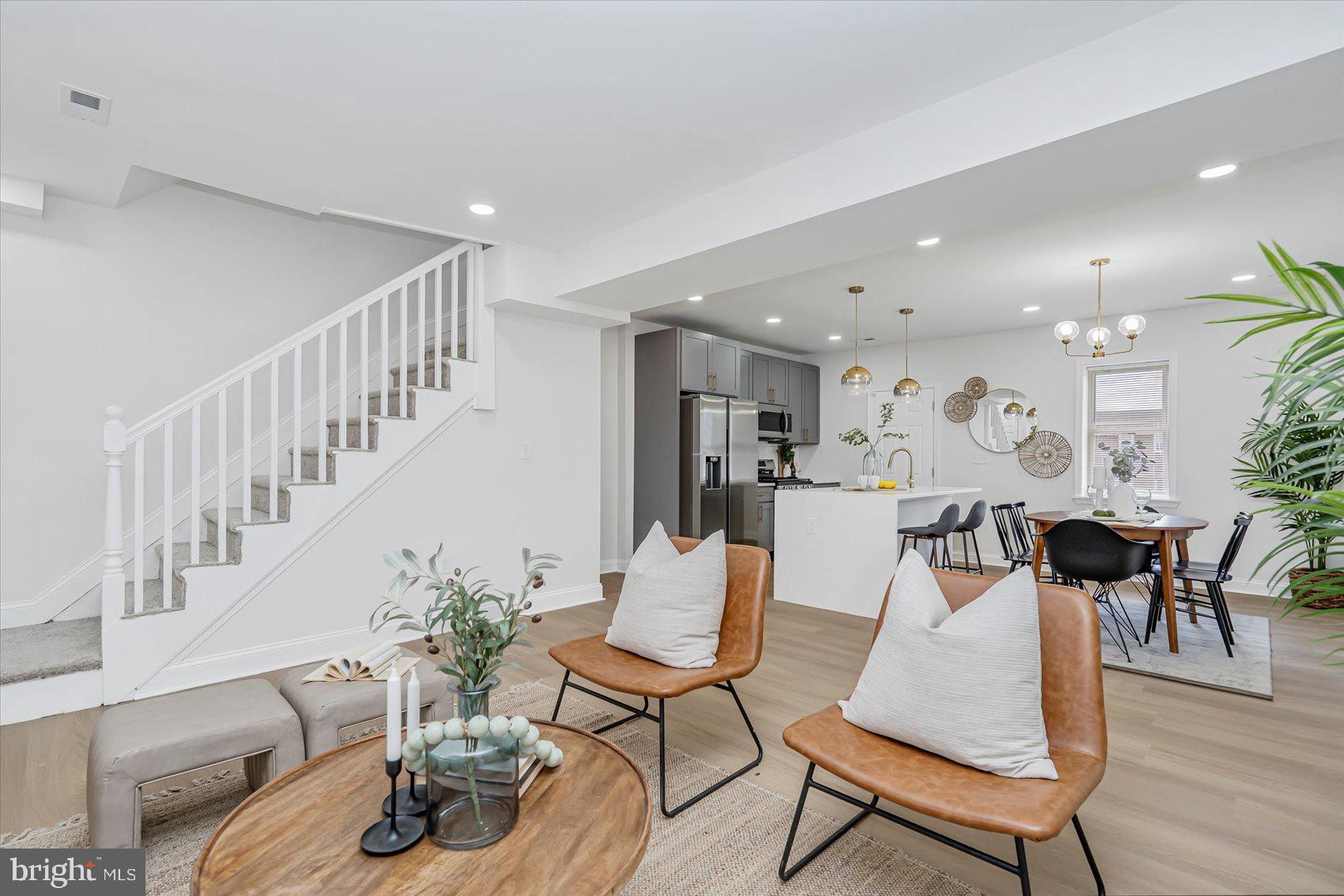 5412 Clover Road Baltimore, MD 21215 - Photo 6 of 42 a living room with furniture kitchen view and a wooden floor