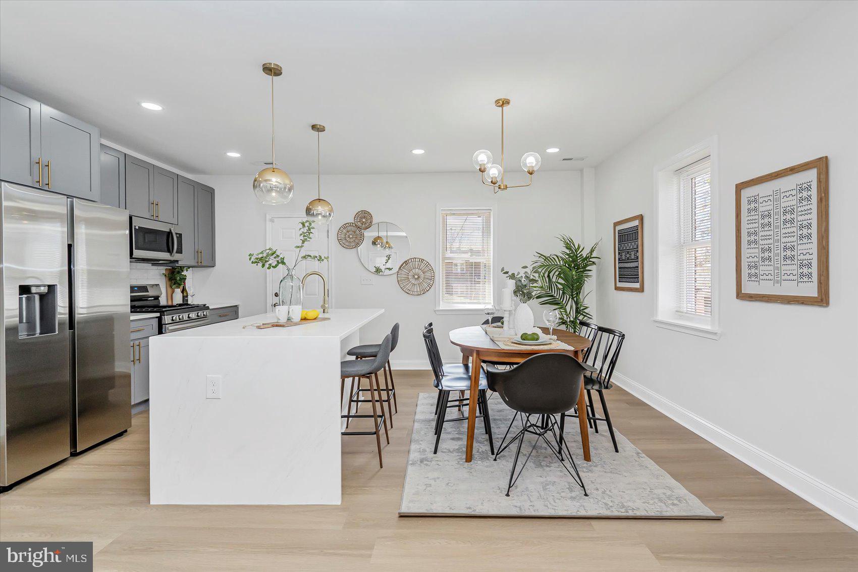5412 Clover Road Baltimore, MD 21215 - Photo 8 of 42 a dining room with kitchen island a table and chairs
