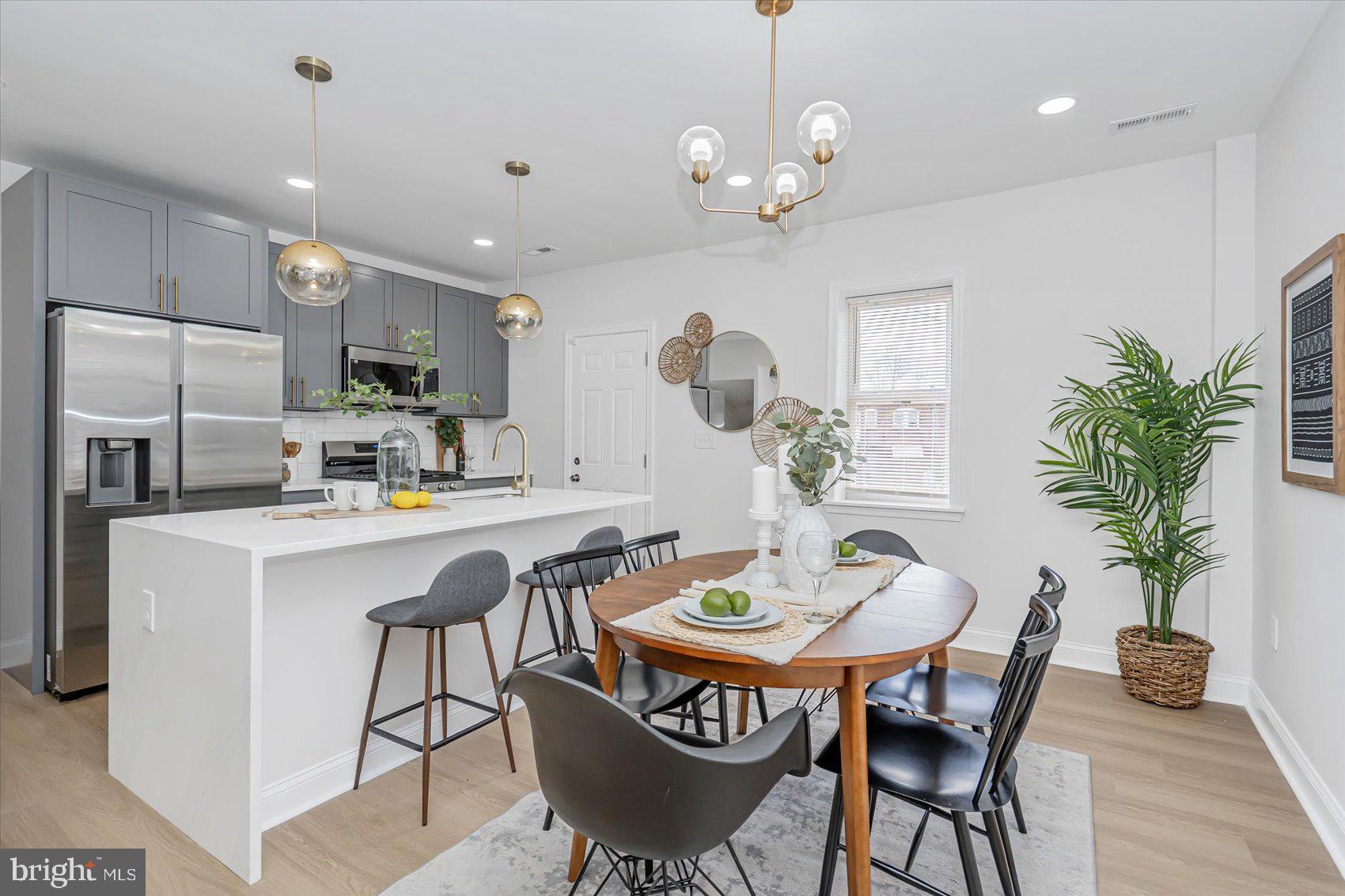 5412 Clover Road Baltimore, MD 21215 - Photo 10 of 42 a kitchen with a table and chairs in it
