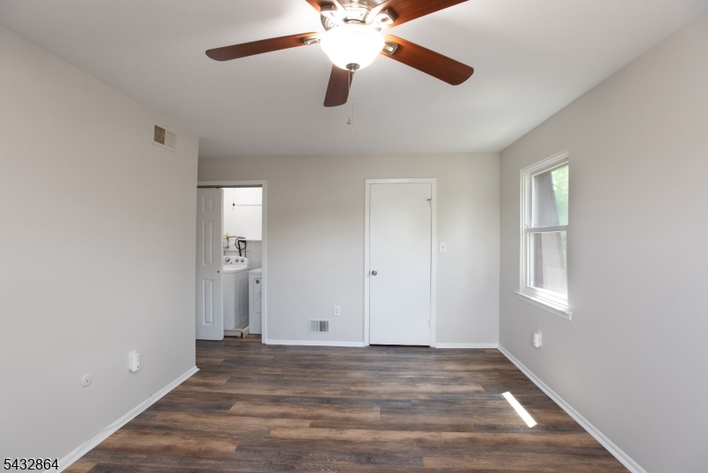 504 Nottingham Way, Unit 504 Flemington, NJ 08822 - Photo 4 of 12 wooden floor in an empty room with a window
