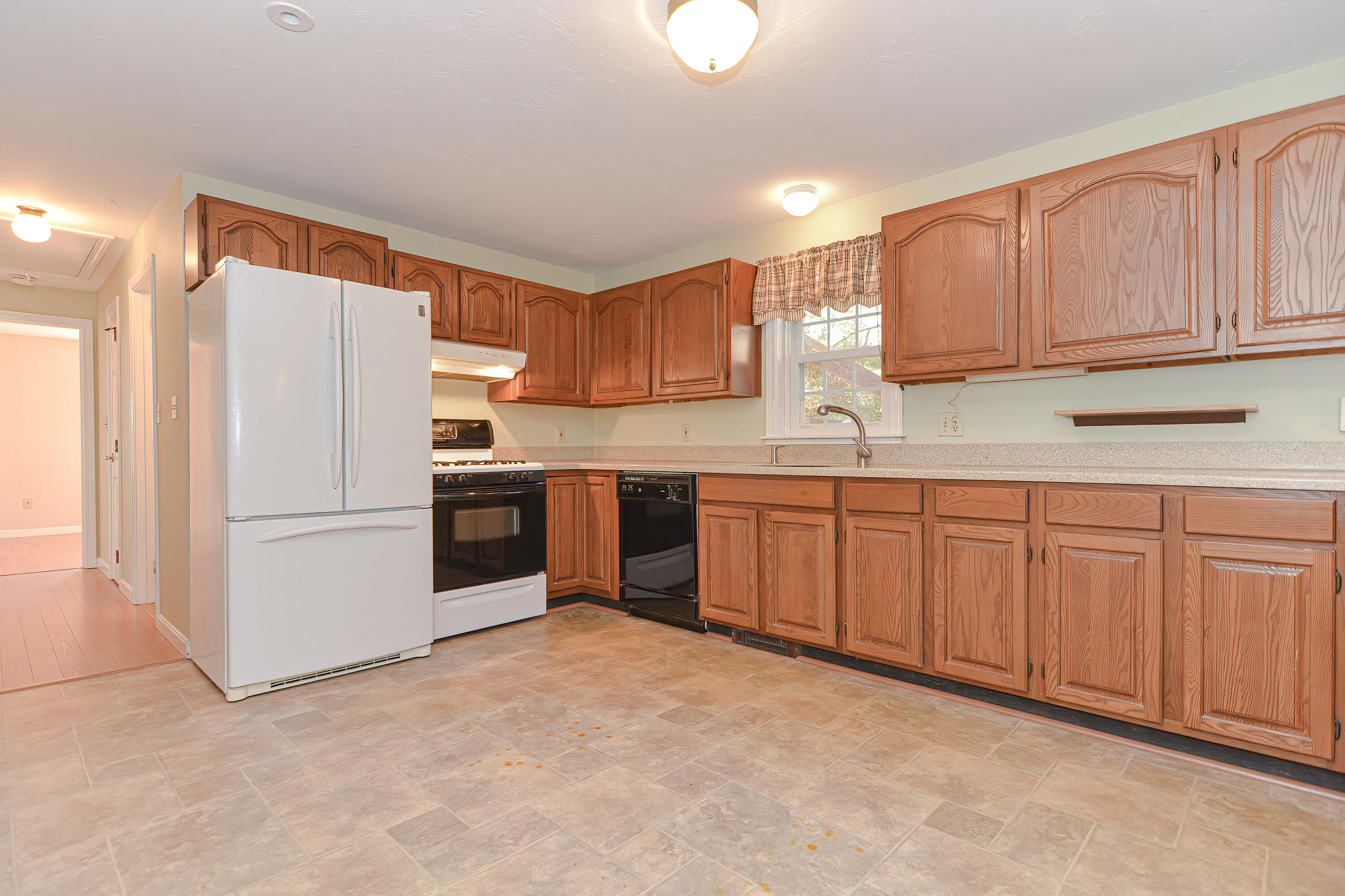 235 Simon Narrows Road Mashpee, MA 02649 - Photo 3 of 30 a kitchen with stainless steel appliances granite countertop a refrigerator sink and cabinets