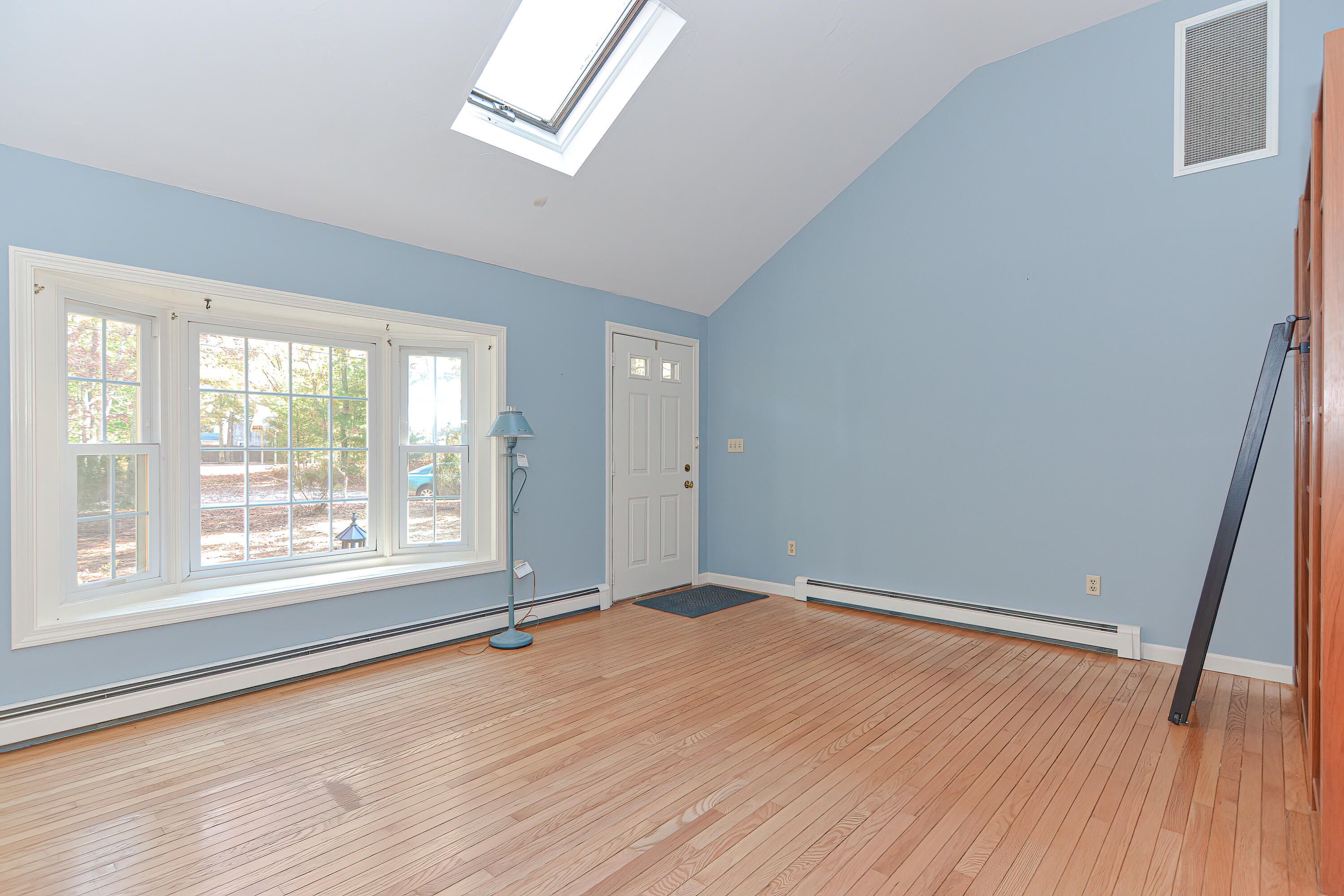 235 Simon Narrows Road Mashpee, MA 02649 - Photo 7 of 30 an empty room with wooden floor and windows