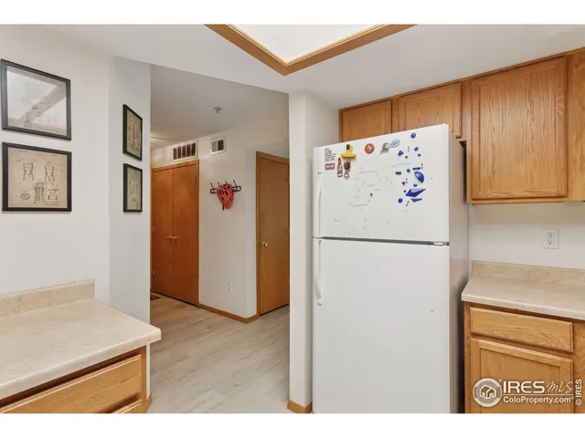 a white refrigerator freezer sitting inside of a kitchen