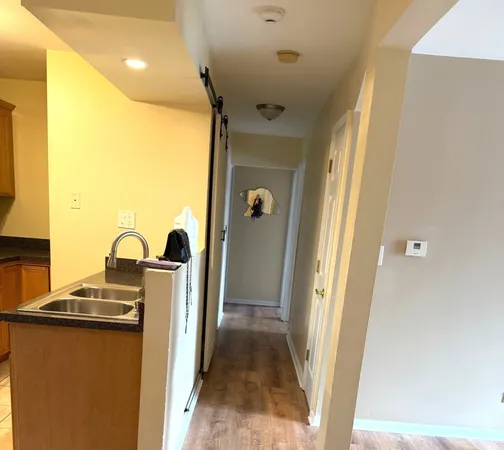 a view of living room with a sink and wooden floor