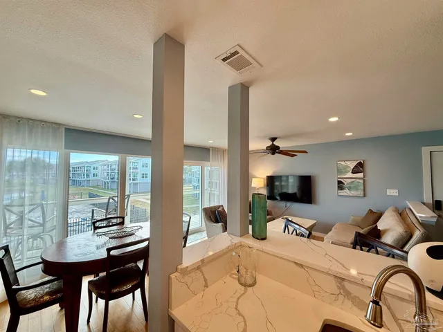 a bedroom with furniture and a large window