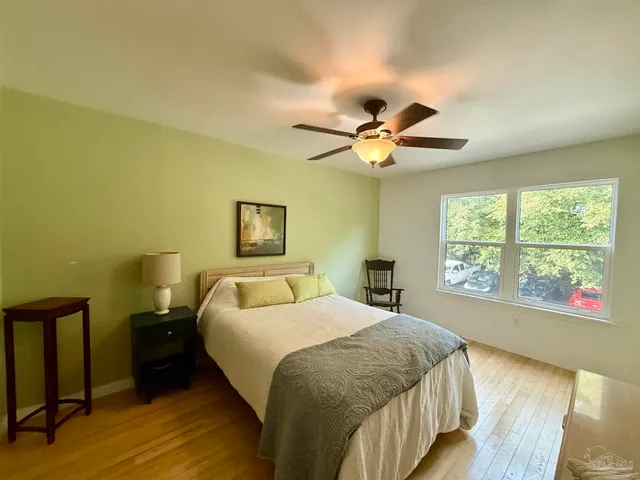 a bedroom with a large bed and a large window