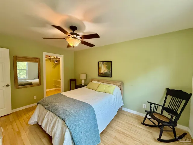 a bedroom with a bed and a chair