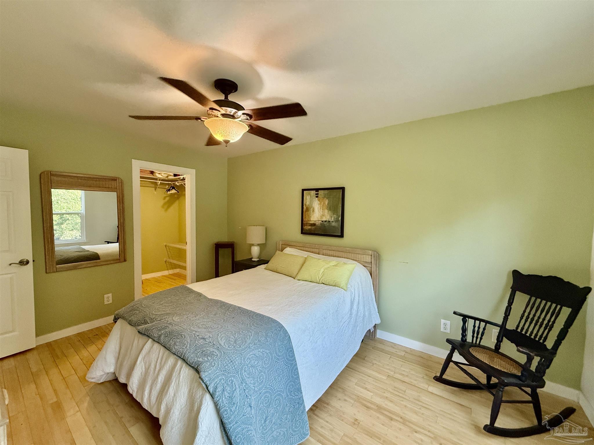 200 Pensacola Beach Road, Unit F3 Gulf Breeze, FL 32561 - Photo 19 of 27 a bedroom with a bed and a chair