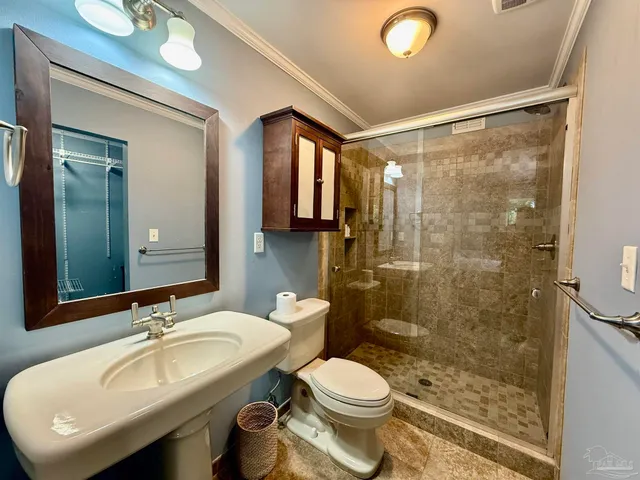 a bathroom with a sink toilet and shower