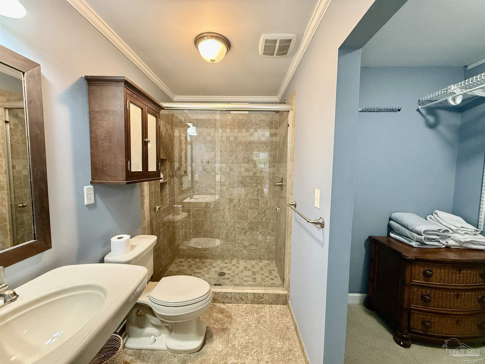 200 Pensacola Beach Road, Unit F3 Gulf Breeze, FL 32561 - Photo 23 of 27 a bathroom with a granite countertop toilet a sink and a mirror