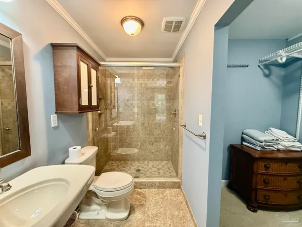 a bathroom with a granite countertop toilet a sink and a mirror
