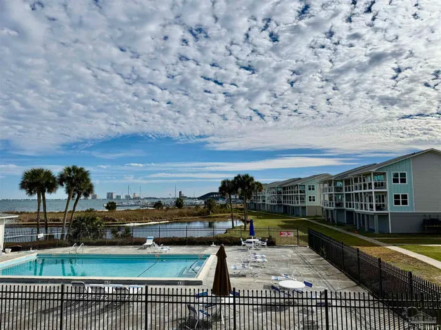 a view of swimming pool with outdoor seating and a garden