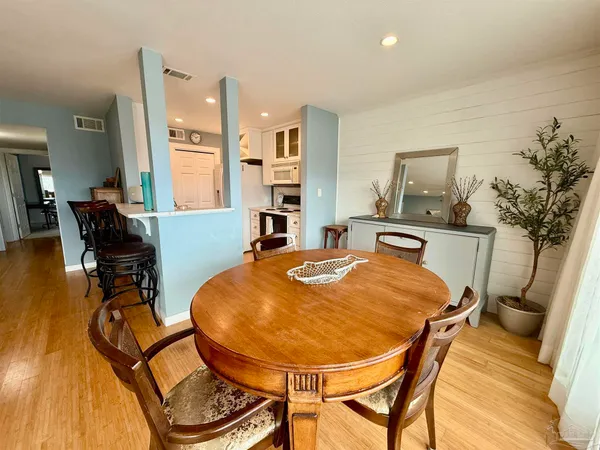 a view of a dining room with furniture and a chandelier