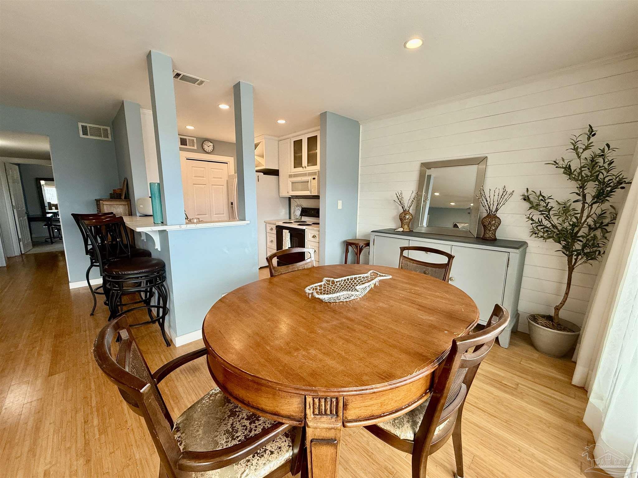 200 Pensacola Beach Road, Unit F3 Gulf Breeze, FL 32561 - Photo 7 of 27 a view of a dining room with furniture and a chandelier