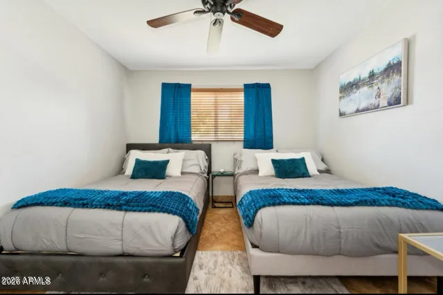 a bedroom with two beds and a chandelier