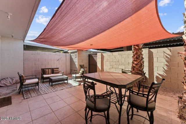 a patio with a table and chairs