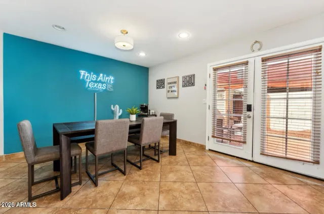 a view of a dining room with furniture a rug and a window