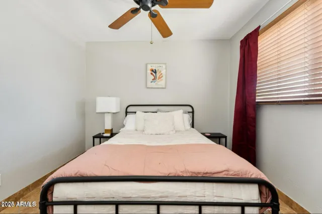 a bedroom with a bed and window