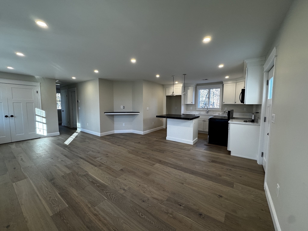 1 A Old Mill Road, Unit 2 Maynard, MA 01754 - Photo 2 of 11 a view of kitchen with kitchen island wooden cabinets and stainless steel appliances