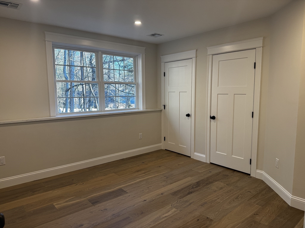 1 A Old Mill Road, Unit 2 Maynard, MA 01754 - Photo 7 of 11 a view of an empty room with wooden floor and a window